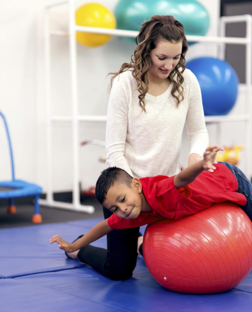 Physical therapist working with child.