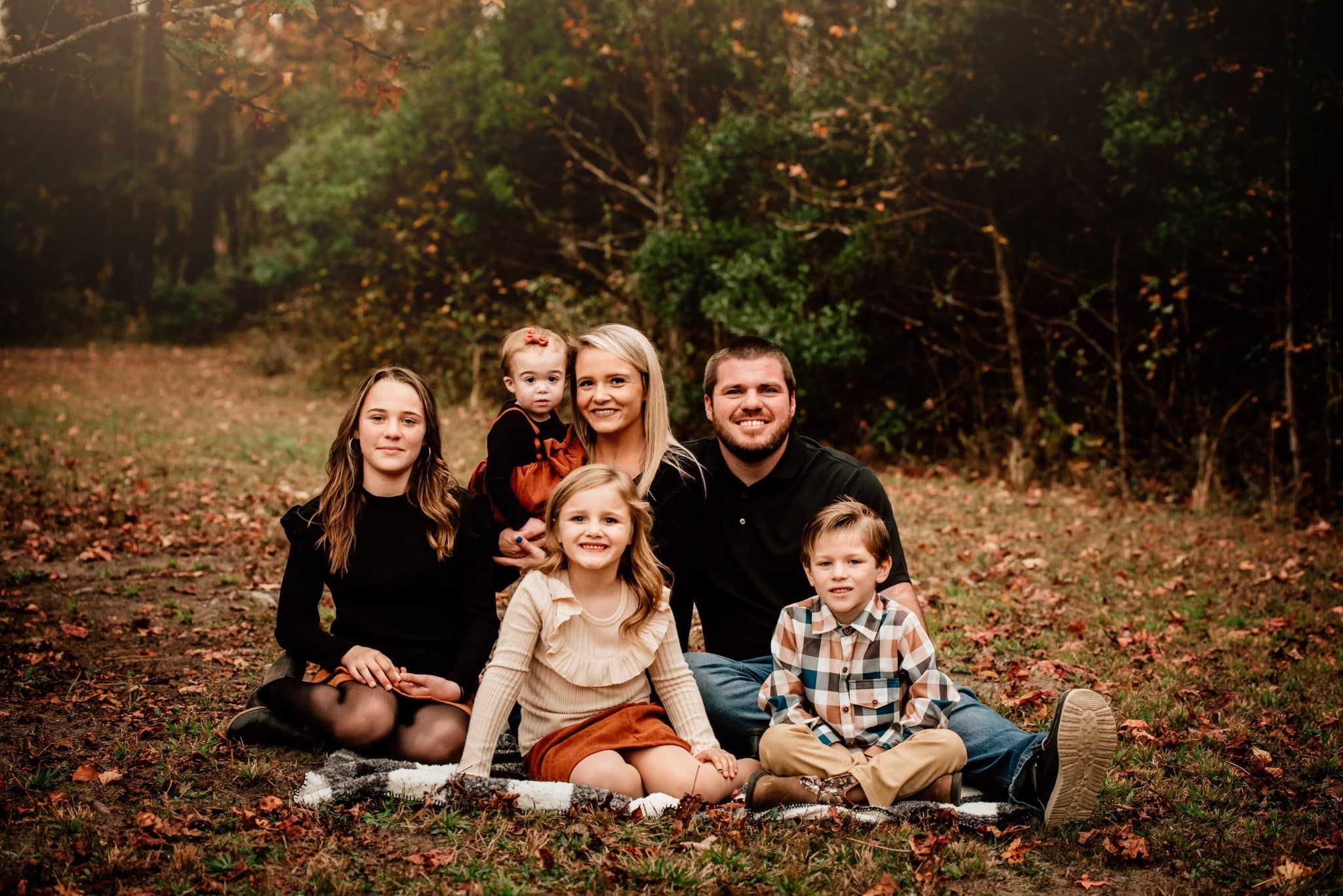 Family portrait with Mother, Father and 3 children outside on fall afternoon.