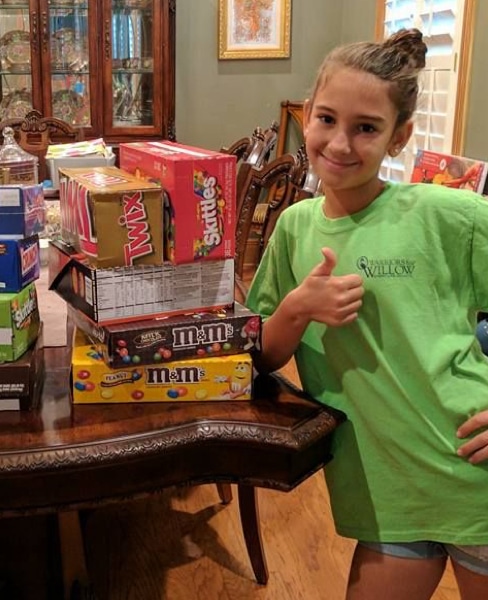 Image of a girl selling candy to raise money for MSD awareness